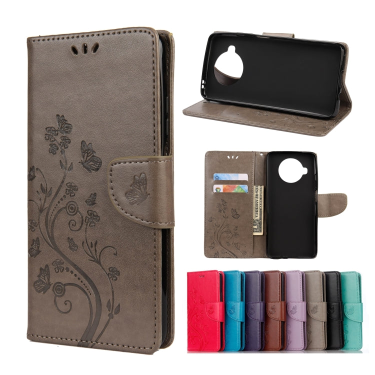Embossed butterfly-and-flower flip leather wallet case with card slots, taupe color