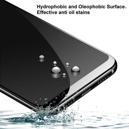 Hydrophobic tempered glass screen protector with water droplets on phone surface