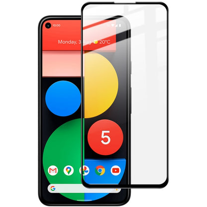 Full-screen tempered glass screen protector aligned on smartphone with rounded corners