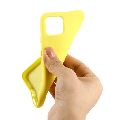 Yellow liquid silicone phone case, shown being placed on a device with camera cutout
