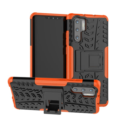 Orange and black tire-tread shockproof phone case with built-in holder