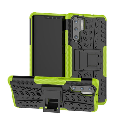 Green and black tire-tread shockproof phone case with built-in holder
