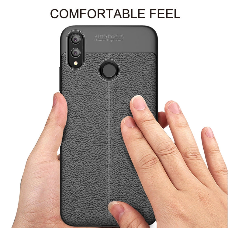 Black litchi-textured TPU phone case with comfortable grip and circular camera ring