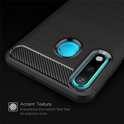 Brushed carbon fiber TPU phone case close-up with blue accent ring and camera cutouts