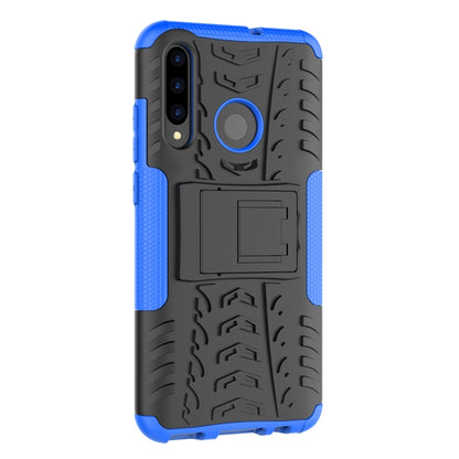 Shockproof phone case with tire tread texture, blue sides, black back, circular holder detail