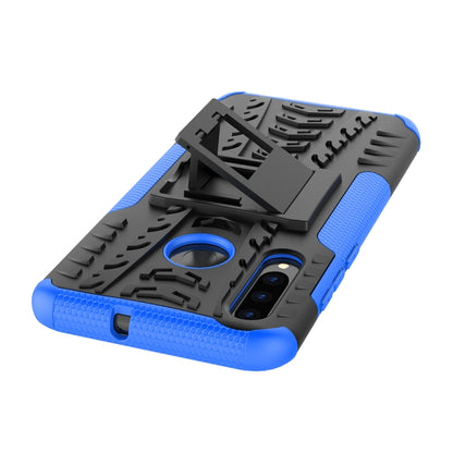 Shockproof phone case top view with tire tread texture, blue grips, holder kickstand