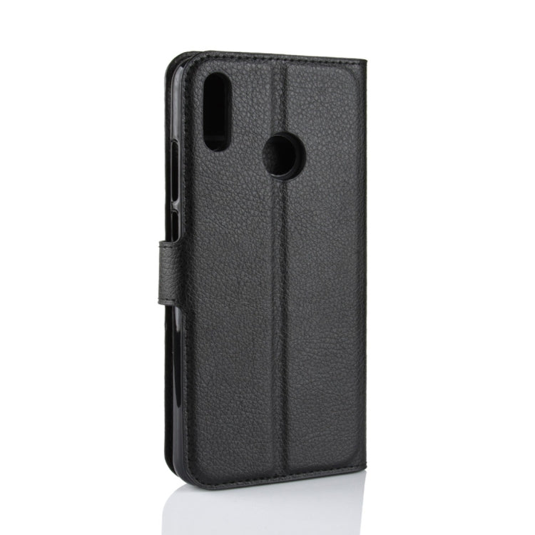Black textured leather flip phone case with cutouts for camera and ports