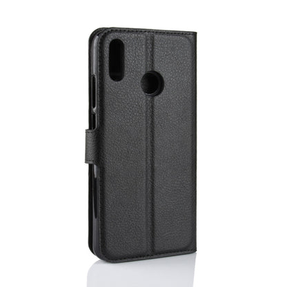 Black textured leather flip phone case with cutouts for camera and ports