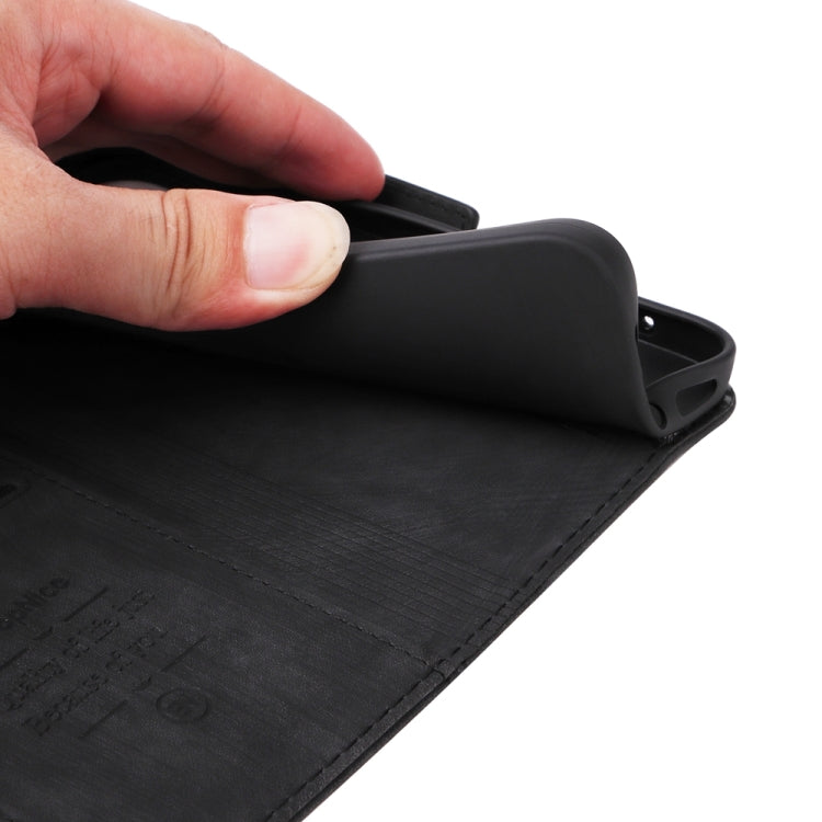 Black leather phone wallet case with stitched texture and flip cover, close-up hand adjustment.