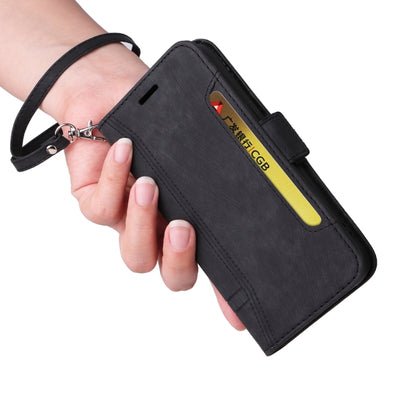 Black leather phone wallet case with wrist strap and vertical card pocket, side view.