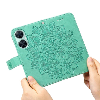 Green embossed floral leather phone case close-up with magnetic strap.