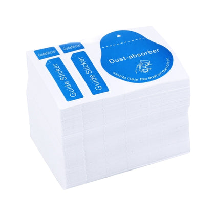 Stack of white backing sheets with blue guide dust-absorber stickers