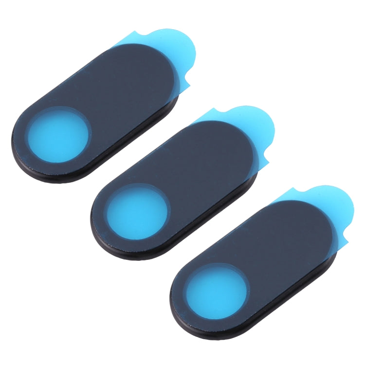 Three black oval webcam covers with blue lens openings, angled view