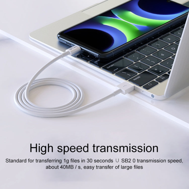 Micro USB charging cable connected to a laptop, white cable