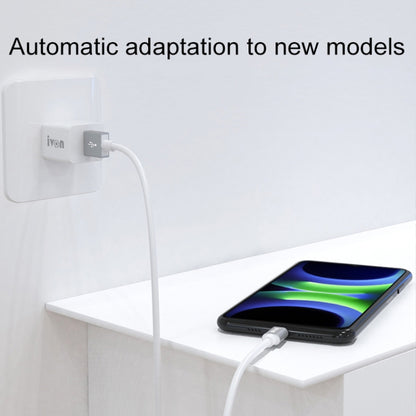 White USB-A to USB-C charging cable connected to wall adapter and phone