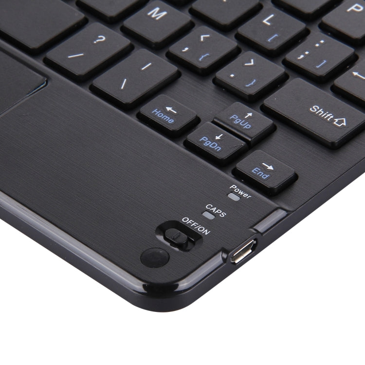 Black Bluetooth keyboard corner with charging port and power controls near touch panel