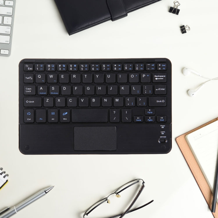 Black Bluetooth keyboard with touch panel on a desk, top view of keys