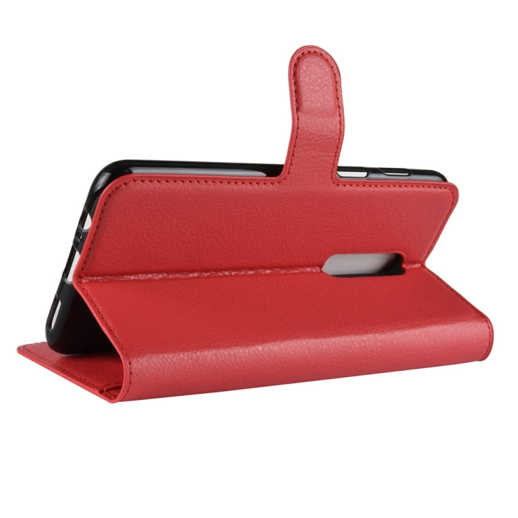 Red leather flip phone case with fold-out stand and side strap