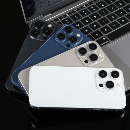 Assorted iPhone 15 Pro dummy display models with black, blue, and white backs