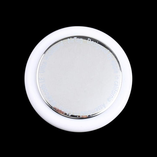 White round tracking tag dummy with clear top and silver ring, front view