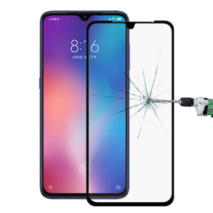 Tempered glass screen protector over smartphone front with visible impact crack pattern