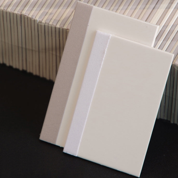 Set of white TPU scratch cards stacked and angled