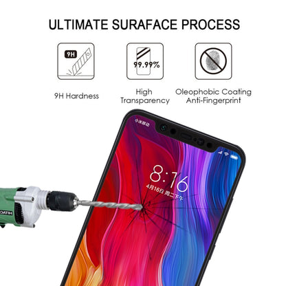 Black tempered glass screen protector for Xiaomi Mi 8 shown during hardness testing.
