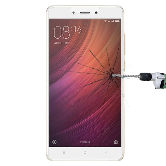 Tempered glass screen protector on smartphone display with cracked impact pattern
