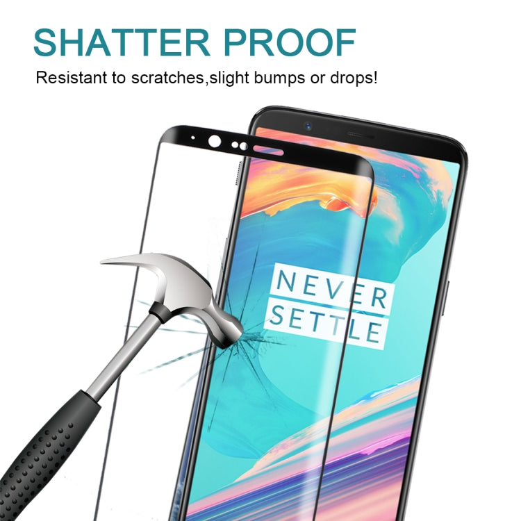 Shatterproof tempered glass screen protector with impact tool near protected phone screen.