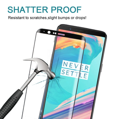 Shatterproof tempered glass screen protector with impact tool near protected phone screen.