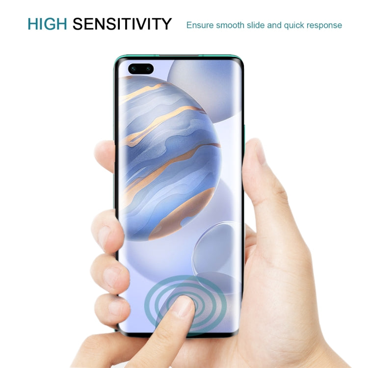Hands applying a clear tempered glass screen protector film to a smartphone