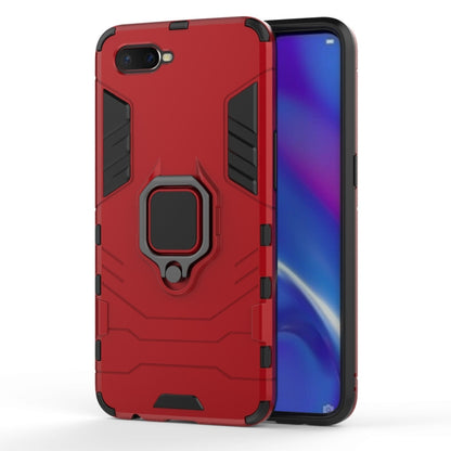 Red shockproof phone case with raised edges and magnetic ring holder stand
