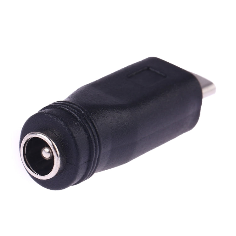 DC 5.5mm barrel female connector end on a black Micro USB power converter adapter