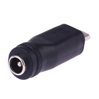 DC 5.5mm barrel female connector end on a black Micro USB power converter adapter