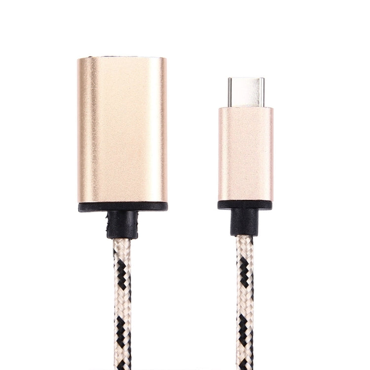 Close-up of gold USB-C male and USB 2.0 female ports on braided cable with black caps