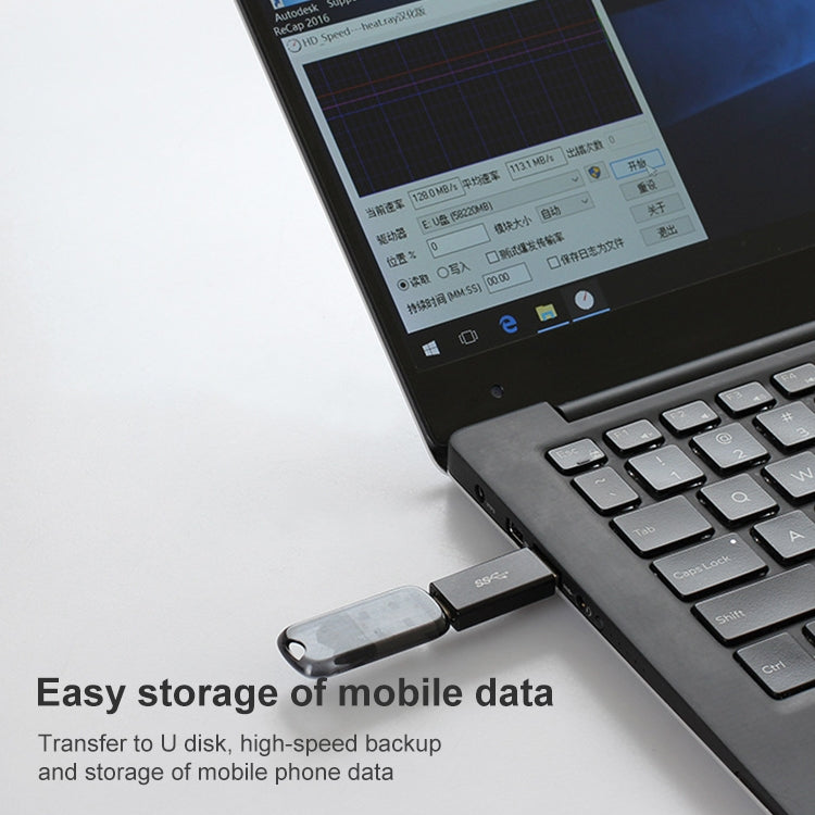 Black USB-C to USB-A adapter plugged into a laptop for data transfer