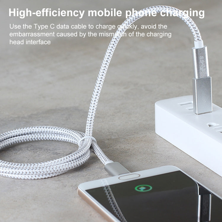 USB-C to USB-A adapter cable connected for phone charging near a smartphone