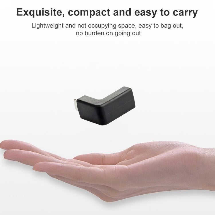 Black 90-degree Type-C to USB adapter held in a hand