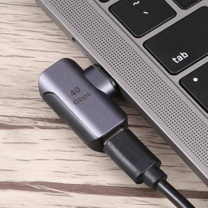 Dark gray 40Gbps USB-C elbow adapter connected to a device cable