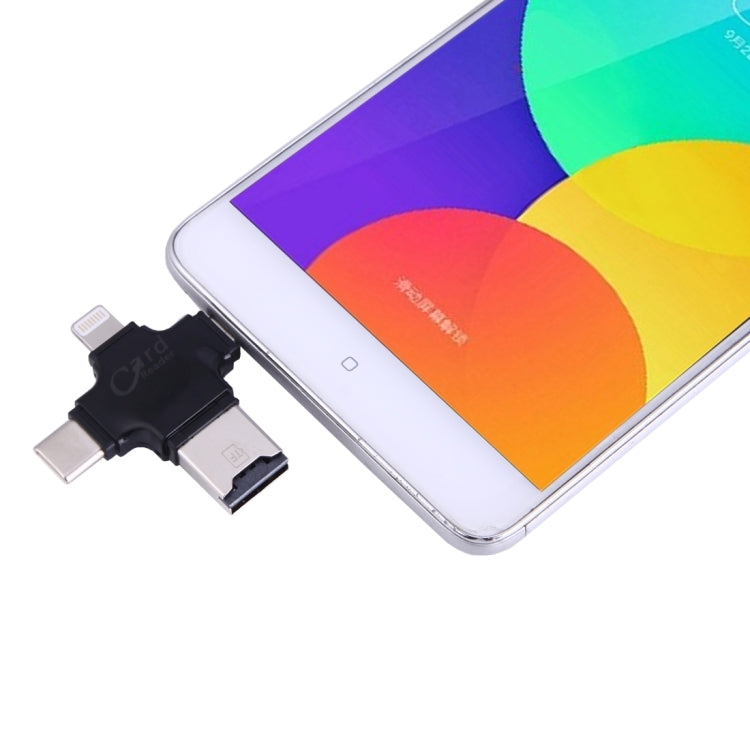 Black 4-in-1 card reader adapter connected to a smartphone