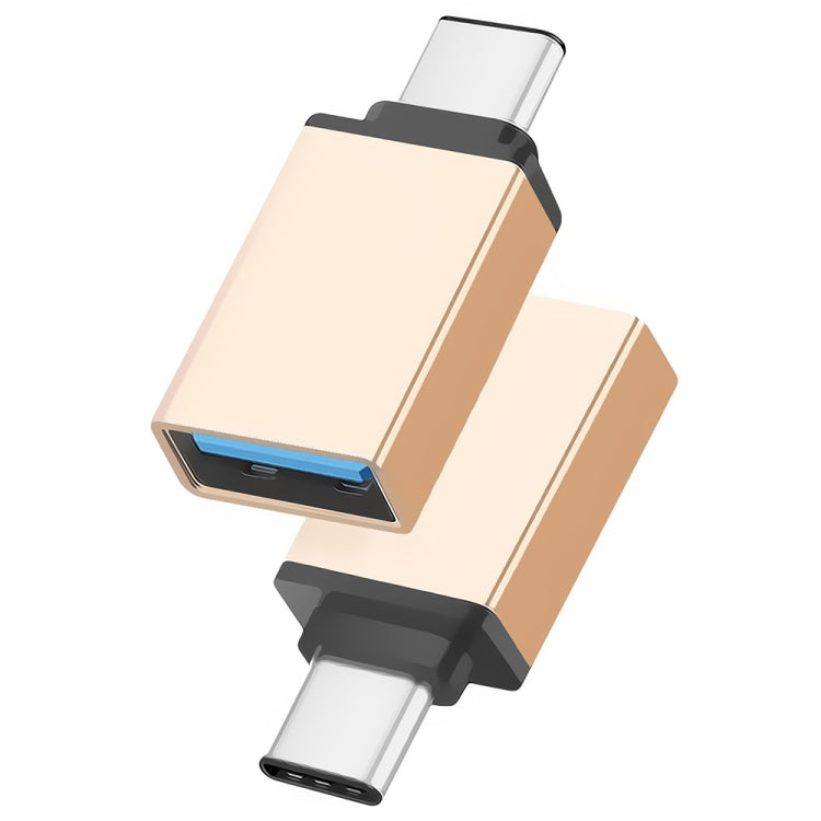 Metal USB-C to USB 3.0 adapter in gold color, blue USB port and black housing