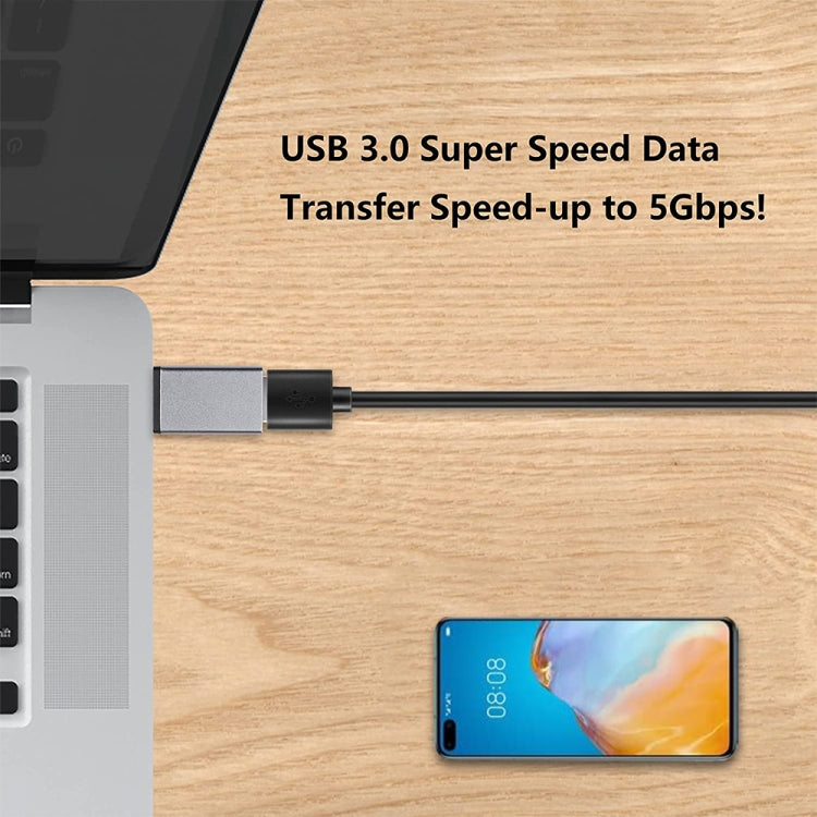 USB 3.0 data adapter plug with blue-tinted USB port connecting to phone