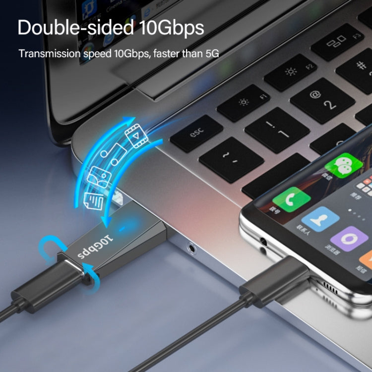 USB 3.1 male-to-USB-C female adapter plugged into a laptop USB-C port