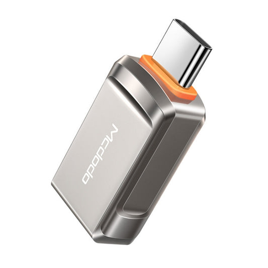 USB-C OTG converter adapter with silver body and orange accent, angled connector