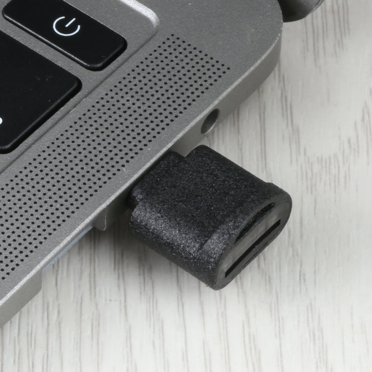 USB-C to TF card reader adapter plugged into device port, black housing