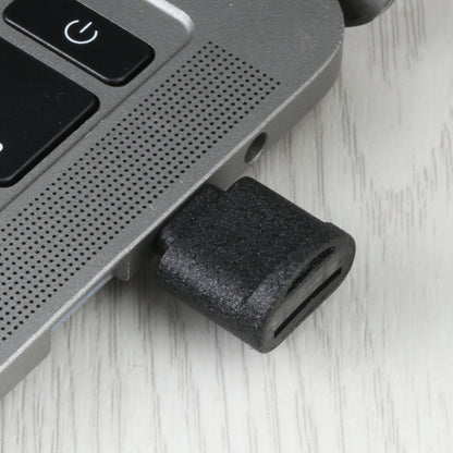 USB-C to TF card reader adapter plugged into device port, black housing