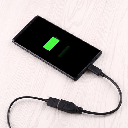 USB-C OTG adapter cable with USB-A plug connected to a device, black