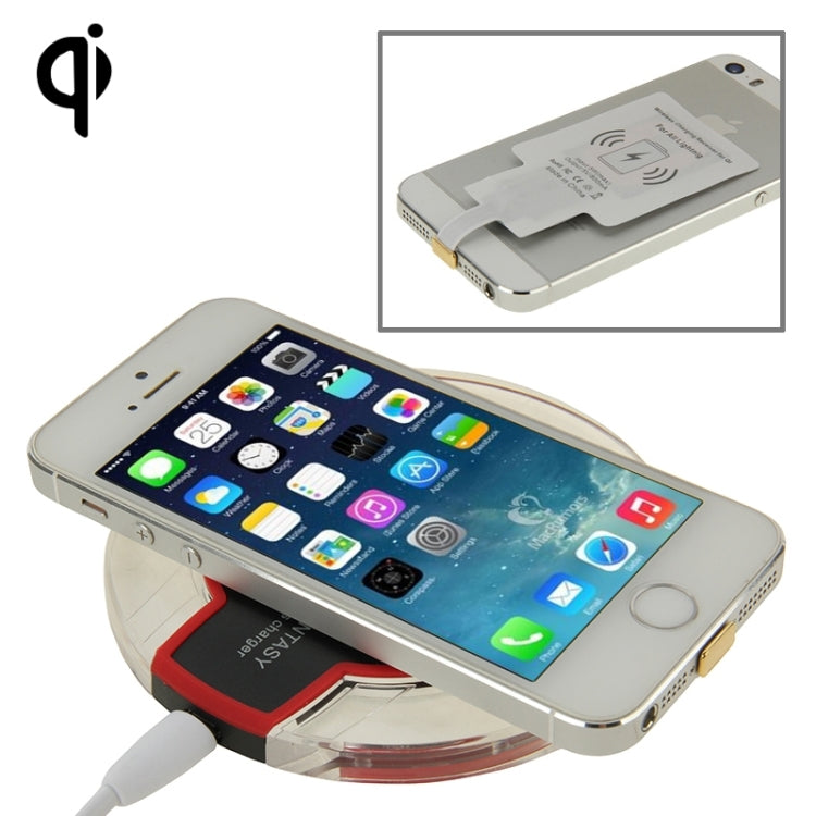 White wireless charging receiver on an iPhone, charging pads visible