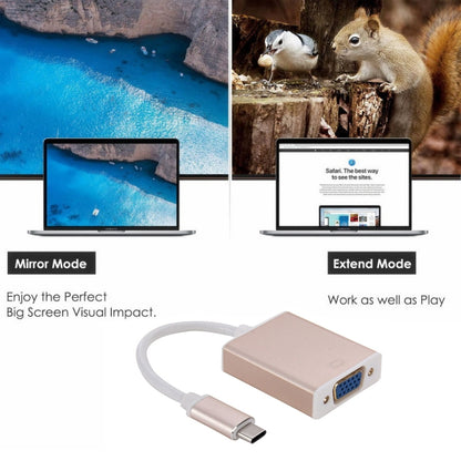 Rose gold USB-C to VGA adapter cable connected to a laptop for display output.