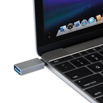 Silver USB 3.0 to USB-C converter adapter plugged into laptop USB port